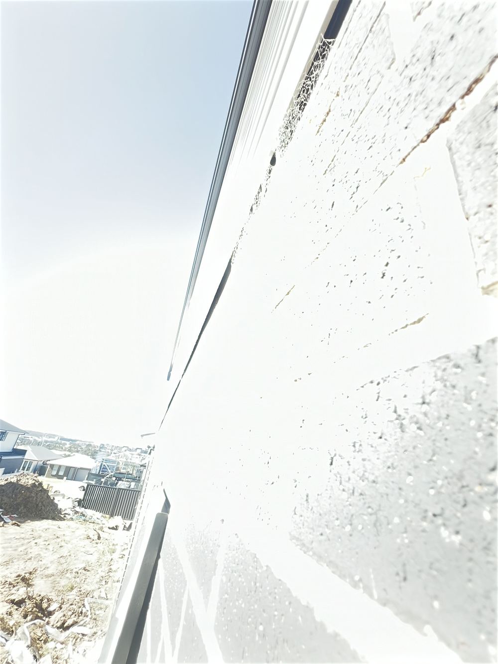 Gap where timber cladding meets brickwork, Cobbitty